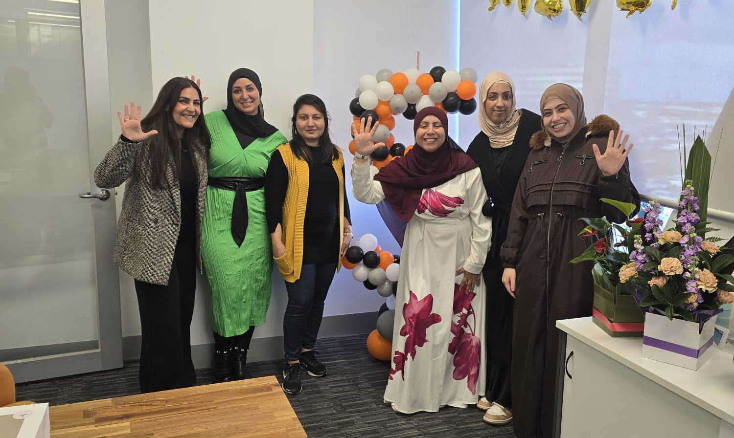 Diverse team of support workers gathering in a welcoming community space